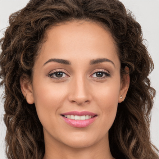 Joyful white young-adult female with long  brown hair and brown eyes