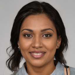 Joyful black young-adult female with medium  brown hair and brown eyes