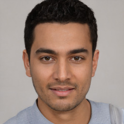 Joyful latino young-adult male with short  black hair and brown eyes