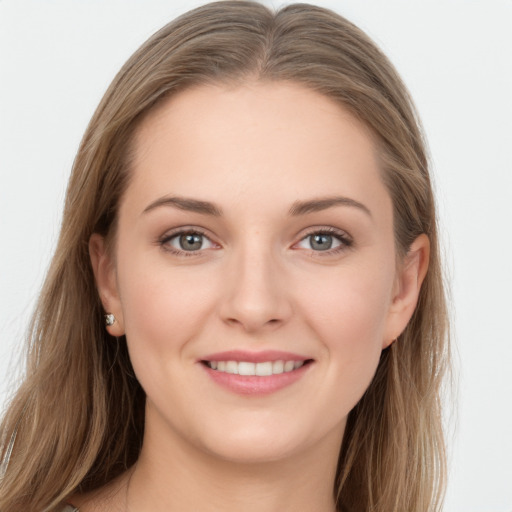 Joyful white young-adult female with long  brown hair and grey eyes