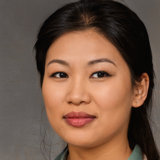 Joyful asian young-adult female with long  brown hair and brown eyes