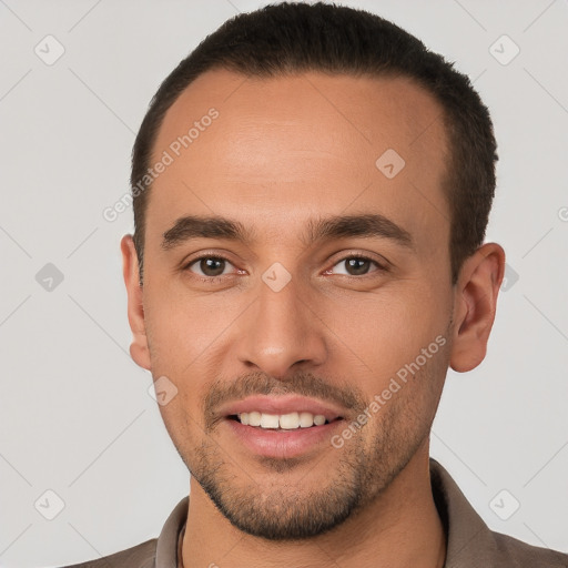 Joyful white young-adult male with short  brown hair and brown eyes