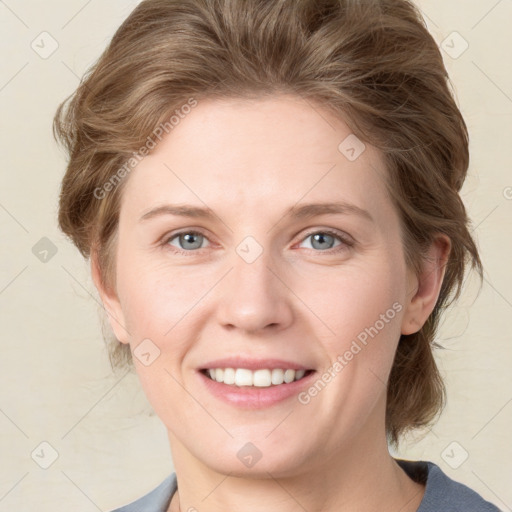 Joyful white young-adult female with medium  brown hair and blue eyes