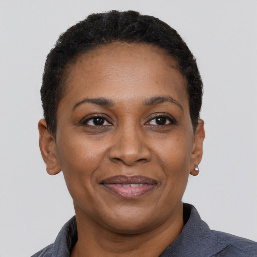 Joyful black adult female with short  black hair and brown eyes