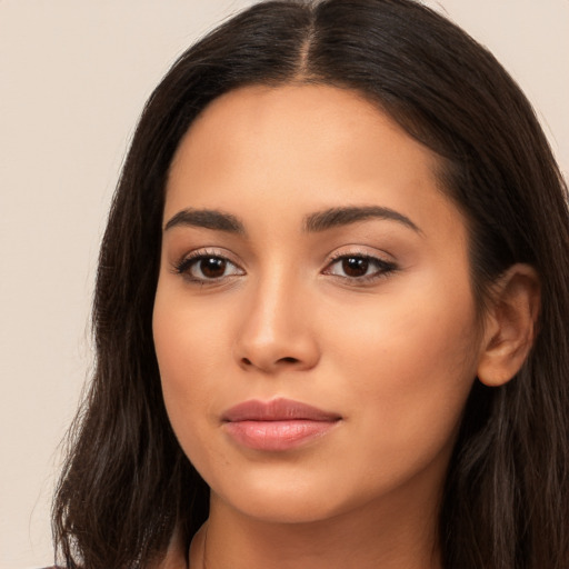 Joyful latino young-adult female with long  brown hair and brown eyes