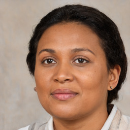 Joyful black adult female with medium  brown hair and brown eyes