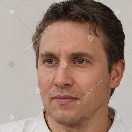 Joyful white adult male with short  brown hair and brown eyes