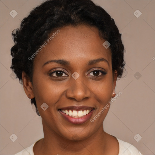 Joyful black young-adult female with short  black hair and brown eyes