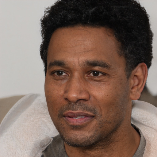 Neutral black adult male with short  black hair and brown eyes