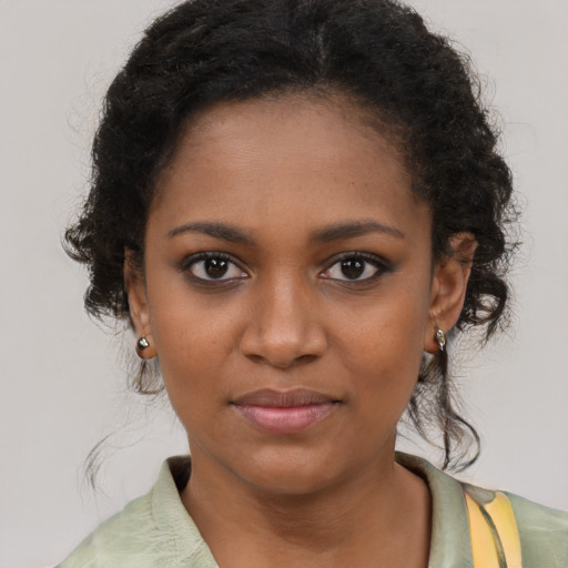 Joyful black young-adult female with medium  brown hair and brown eyes