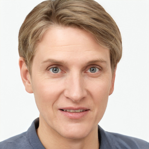 Joyful white adult male with short  brown hair and blue eyes