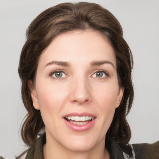 Joyful white young-adult female with medium  brown hair and grey eyes