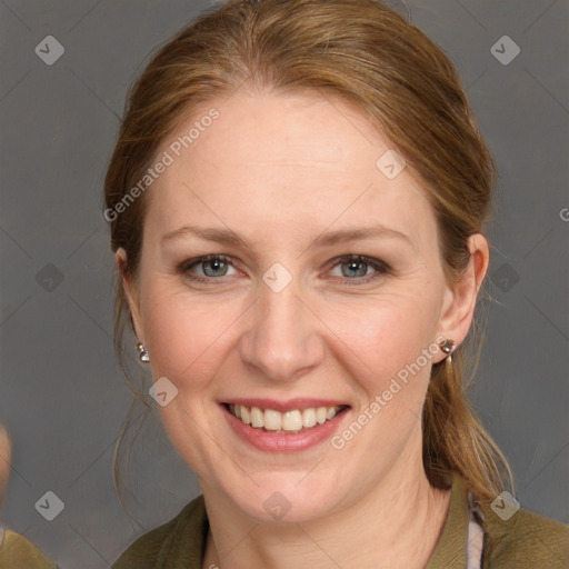 Joyful white adult female with medium  brown hair and grey eyes