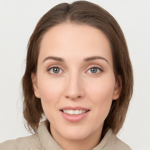 Joyful white young-adult female with medium  brown hair and green eyes