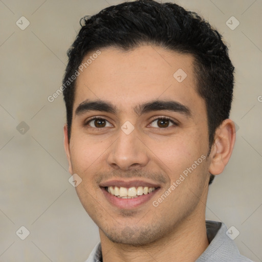 Joyful white young-adult male with short  black hair and brown eyes