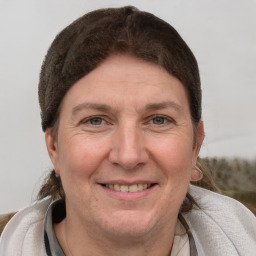 Joyful white adult female with short  brown hair and brown eyes