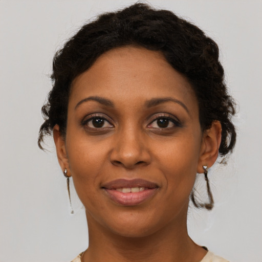 Joyful latino young-adult female with medium  brown hair and brown eyes