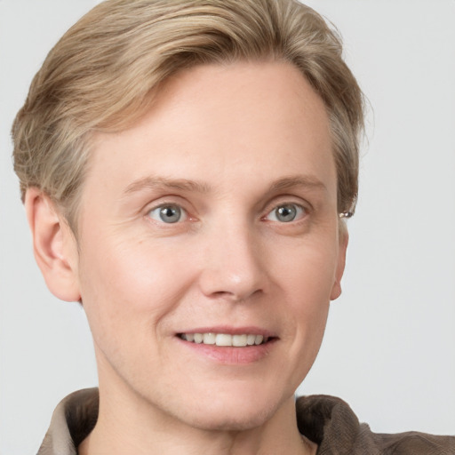 Joyful white adult male with short  brown hair and grey eyes