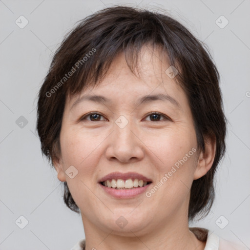 Joyful white adult female with medium  brown hair and brown eyes