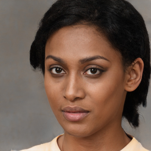 Neutral black young-adult female with medium  black hair and brown eyes