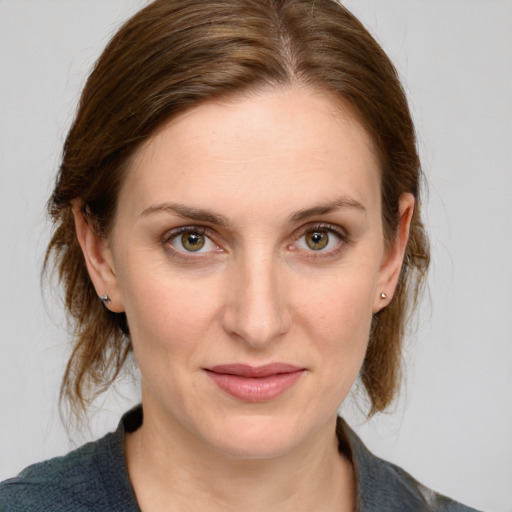 Joyful white young-adult female with medium  brown hair and grey eyes