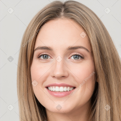 Joyful white young-adult female with long  brown hair and green eyes