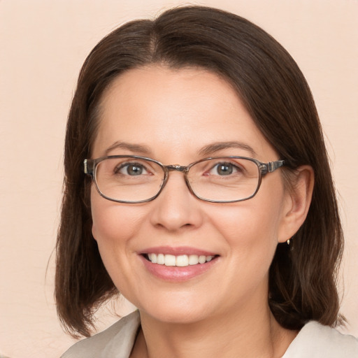 Joyful white adult female with medium  brown hair and brown eyes