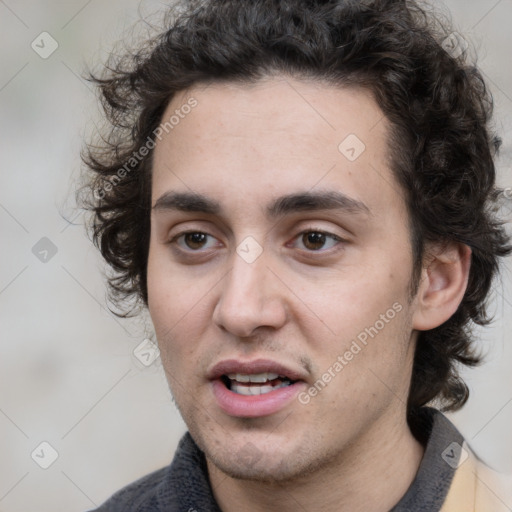 Joyful white young-adult male with medium  brown hair and brown eyes