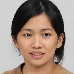 Joyful asian young-adult female with medium  black hair and brown eyes