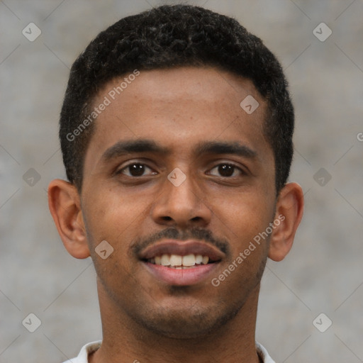 Joyful black young-adult male with short  brown hair and brown eyes