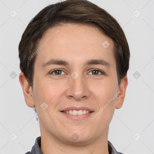 Joyful white young-adult male with short  brown hair and grey eyes