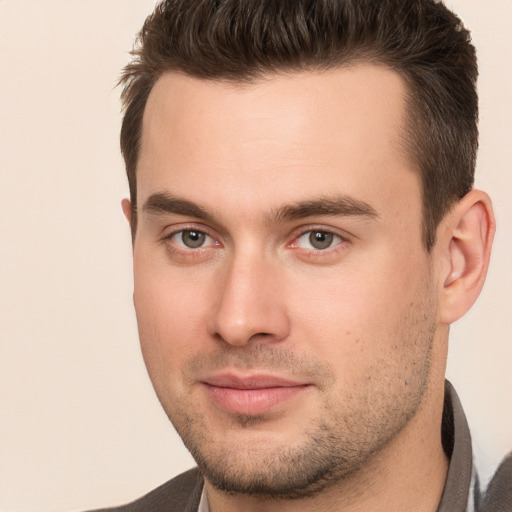 Joyful white young-adult male with short  brown hair and brown eyes