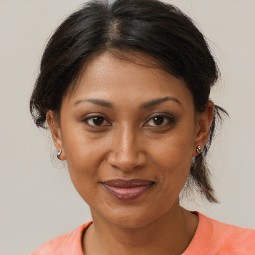 Joyful black adult female with medium  brown hair and brown eyes