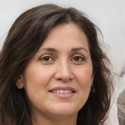 Joyful white adult female with long  brown hair and brown eyes