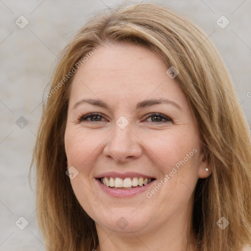 Joyful white adult female with long  brown hair and brown eyes