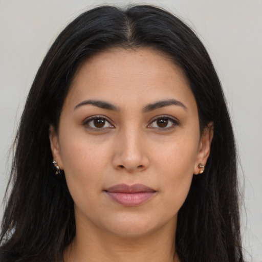 Joyful latino young-adult female with long  brown hair and brown eyes