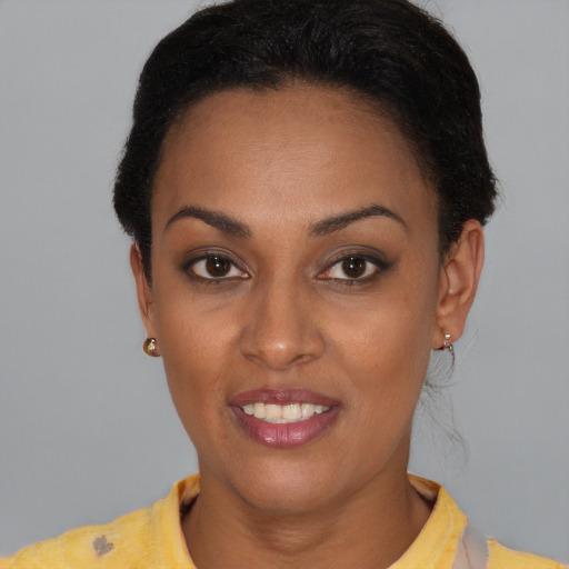 Joyful black young-adult female with short  brown hair and brown eyes