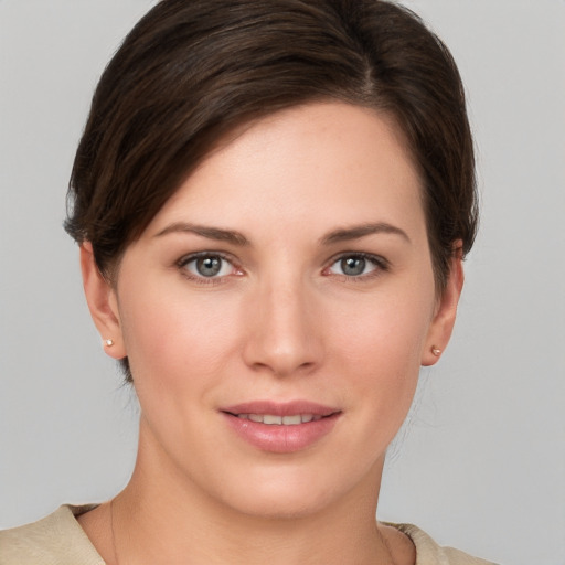 Joyful white young-adult female with short  brown hair and grey eyes