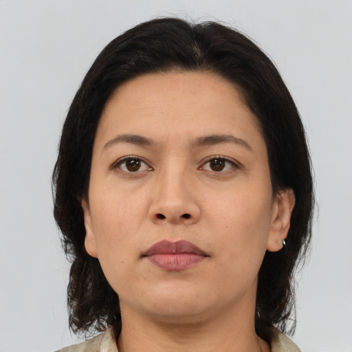Neutral latino adult female with medium  brown hair and brown eyes