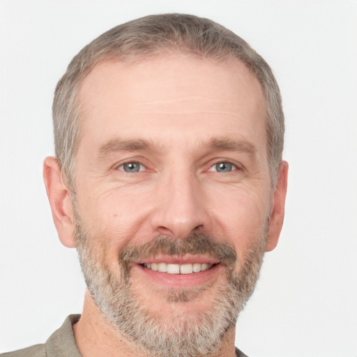 Joyful white adult male with short  brown hair and grey eyes