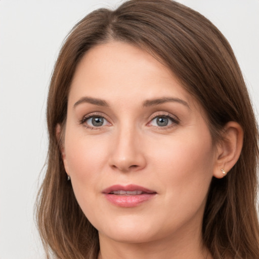 Joyful white young-adult female with long  brown hair and grey eyes