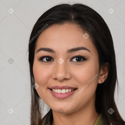 Joyful latino young-adult female with long  brown hair and brown eyes