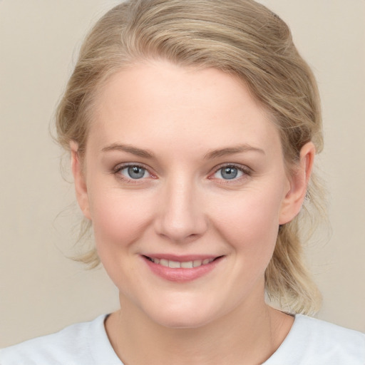 Joyful white young-adult female with medium  brown hair and blue eyes