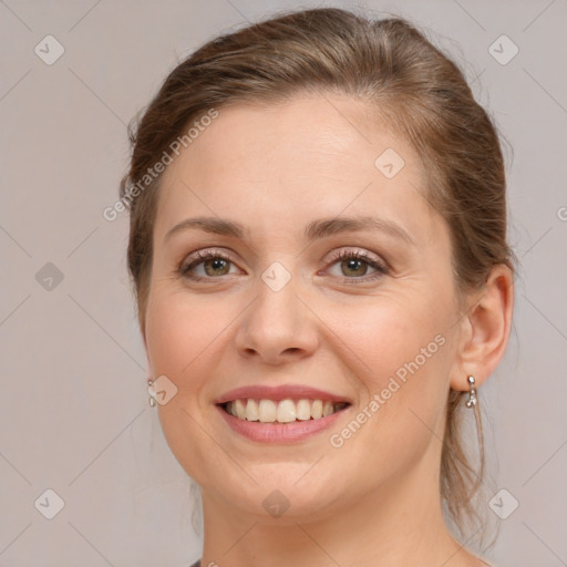 Joyful white young-adult female with medium  brown hair and green eyes