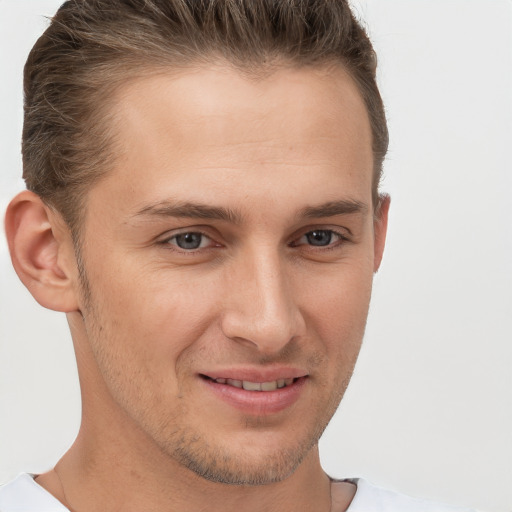 Joyful white young-adult male with short  brown hair and brown eyes