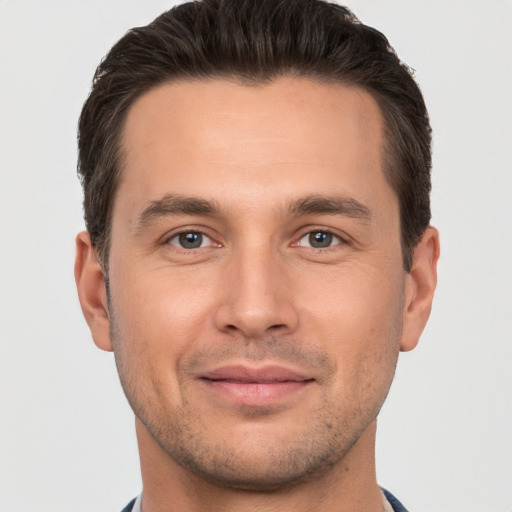 Joyful white young-adult male with short  brown hair and brown eyes