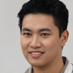 Joyful asian young-adult male with short  black hair and brown eyes