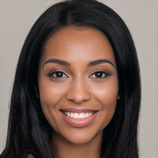 Joyful latino young-adult female with long  black hair and brown eyes