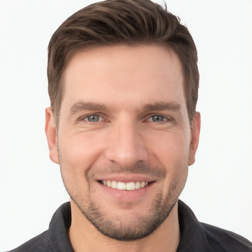 Joyful white young-adult male with short  brown hair and grey eyes