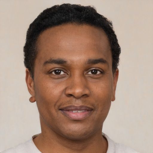 Joyful black young-adult male with short  black hair and brown eyes